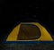 Closeup orange touristic tent under starry night sky