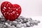 Closeup of an ornamental red velvet heart with glowing stones on the white background
