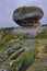 Closeup of outcrops covered in mosses and grass under a cloudy sky in Portugal