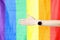 Closeup of outstretched hand with wristwatch against lgbt flag background