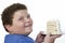 Closeup Of An Overweight Boy Holding Large Slice Of Cake