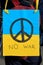 Closeup on packard with with pacific sign on Ukrainian yellow blue flag. Protest against war in Ukraine.