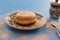 Closeup of Paczki with powdered sugar on Polish pottery plate