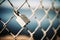 Closeup of a padlock on a barbed wire fence under the sunlight