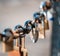 Closeup of a padlock hanging on chain link of the bridge / Fence