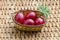 Closeup paint Easter red eggs in the basket on wicker table