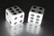 Closeup of a pair of dice on a reflective surface