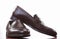 Closeup of Pair of Stylish Brown Penny Loafer Shoes Against White.