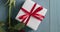 Closeup pan of red rose with gift on blue wood table