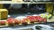 Closeup panorama on assortment of different sweet cake pieces and fruit eclairs