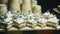 Closeup panorama at assortment of sweet cake pieces decorated with white cream