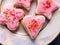 Closeup panorama on heap of assorted white and pink macaroons with white creamy filling served on big plate