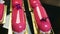 Closeup panorama on pink glazed eclairs decorated with violet and white flowers