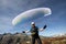 Closeup of a paraglider pilot balancing his paraglider above his head