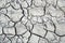 Closeup of a Parched, cracked earth during summer drought.