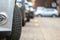 Closeup of parked car on a city street side with new winter rubber tires