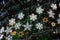 Closeup of a part of christmas tree decorated by lights and snowflakes