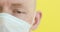 Closeup part of sick man face in medical protective mask in covid-19 pandemic.