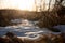 Closeup of patch of snow and prairie grass at sunset