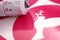 closeup on peace dove symbol of a pink vinyl sticker on white carrier paper. closely lying adjustable plotting blade