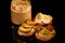 closeup peanut butter in glass jar with green grapes