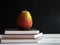 Closeup Pear put on three books stacked on wooden timber board,vintage warm light tone