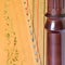 Closeup of pedal harp column strings and soundboard