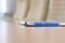 Closeup pen on table in empty corporate conference room before business meeting