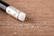 Closeup pencil eraser on wooden table, soft focus