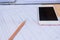 Closeup pencil with finance business sheet and phone . Business concept.