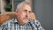 Closeup pensive elderly man suffering loneliness hopeless aging dementia disease sitting in armchair