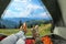 Closeup of people in camping tent with sleeping bags on mountain hill