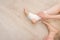 Closeup People of a Foot with White Gauze Elastic Bandage. Hands on Injured Legs and Feet on Pain Area. Asian Young Woman Ankle