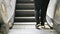 Closeup of people stepping onto an escalator