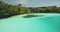 Closeup people swim at turquoise crystal clean water of Weekuri lake. Amazing Asian tourists landmark