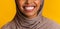 Closeup of perfect white smile of black muslim woman in headscarf