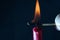 Closeup of a person burning the matchstick on the candle