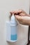 Closeup on person dispensing disinfectant sanitizer liquid onto