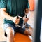 Closeup of a person doing exercises on a rowing machine under the lights