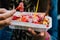 Closeup of a person eating Belgian waffles with strawberries in Brussels