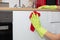 Closeup of a person with gloves cleaning the kitchen cupboards - coronavirus concept
