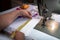 Closeup of a person measuring a facemask with a tape in the workshop