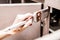 Closeup of Person Painting Kitchen Cabinets