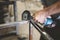 Closeup of a person polishing steel under the lights in a garage