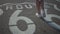 Closeup of a person walking on the asphalt with the Route 66 sign