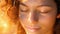 A closeup of a persons face their expression peaceful and their eyes closed as they listen to the healing notes of a