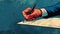 A closeup of a persons hand holding a pen poised to make a signature on a property contract