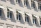 Closeup perspective on grey building with white awning