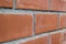 Closeup perspective view of a red brick wall, selective focus