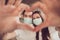 Closeup photo of adorable young couple lady guy spend quarantine together stay home happy making arms fingers heart sign